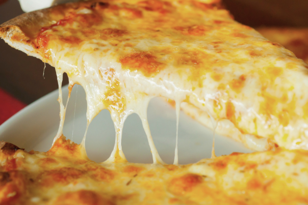 slice of cheese pizza being pulled from pie