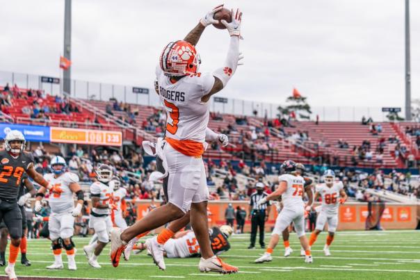 Football player jumping to catch the football