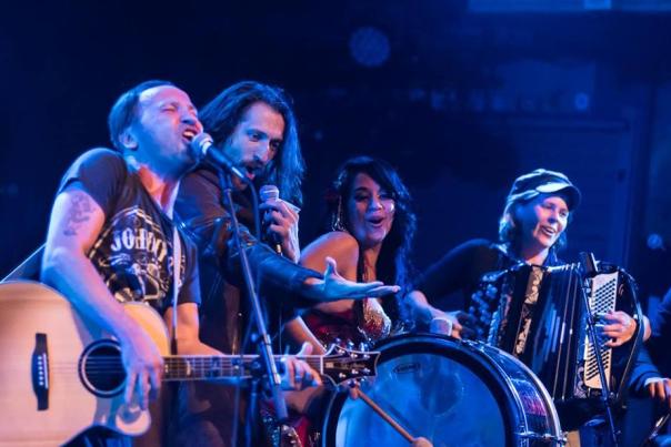 group of people playing instruments and singing