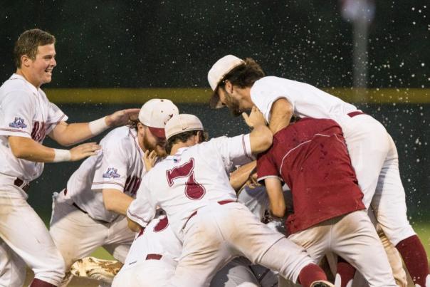 baseball players piled on top of each other while celebrating
