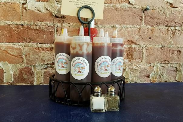 A variety of sauces are available at Holy Smoke Hog Roast Company in Martinsville.
