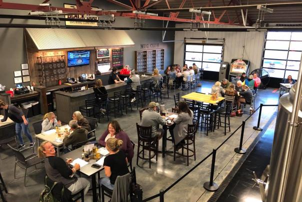 Patrons enjoy locally crafted beer and tasty flat bread pizzas at Black Dog Brewing Company in Mooresville.
