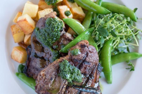 Lamb T-Bone with Roasted Yukon Potatoes, Snap peas, and Herbed Garlic Pesto