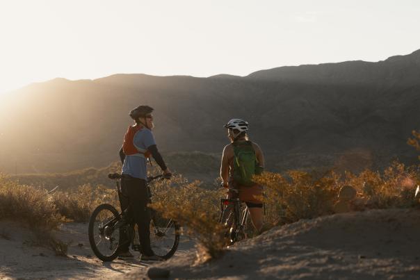 Man and woman mountain biking at dusk near Truth or Consequences, New Mexico