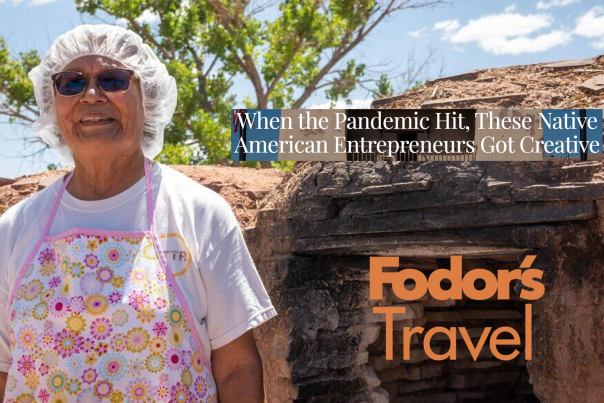 A woman wearing a hairnet and pink apron stands before a traditional building. Text reads, When the Pandemic Hit, These Native American Entrepreneurs Got Creative. Fodors Travel