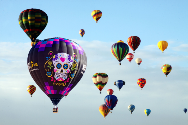 Muerto Balloon joins other hot air balloons in the clear New Mexico sky.