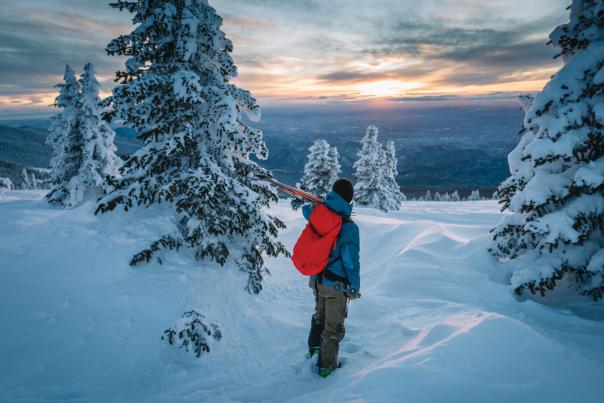 Man Walking Past Snow Covered Trees