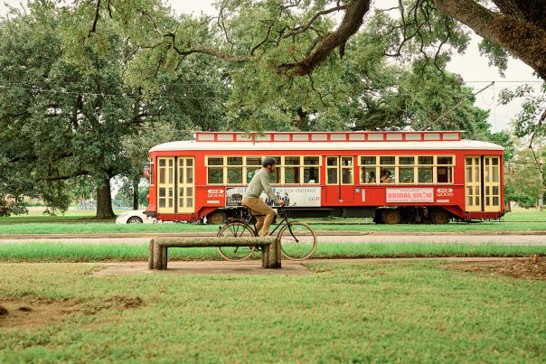 Canal Street Streetcar Passing A Biker in City Park
