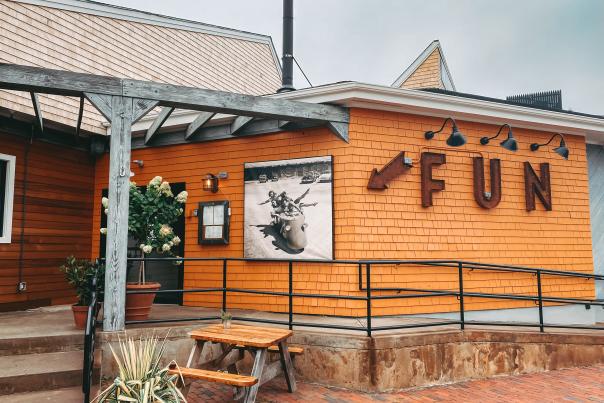 Orange exterior of Stoneacre Garden in Newport, sign spells out "F-U-N"