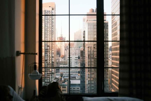 View of the New York City skyline at sunset from inside an apartment, the kind of vista buyers and renters weigh when choosing a unit
