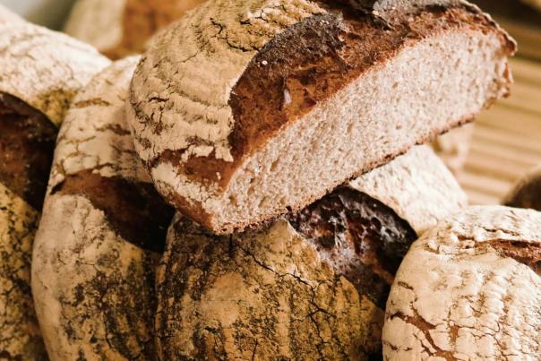 Rustic woodfire-baked sourdough rye bread with a thick dark crust, recalling the overnight fermentation process at Gage and Tollner