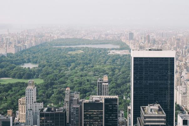 Aerial view of Central Park stretching through Midtown Manhattan surrounded by dense city skyscrapers