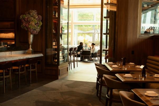 Elegant restaurant interior with candlelit tables, floral arrangements, and warm ambient lighting for a fine dining evening