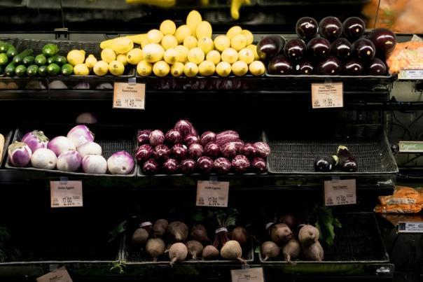 A well-stocked produce section of a grocery store filled with fresh colorful fruits and vegetables representing premium food retail