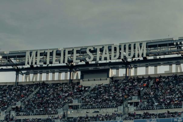 MetLife Stadium upper seating area filled with fans beneath large stadium signage in New Jersey during a live event