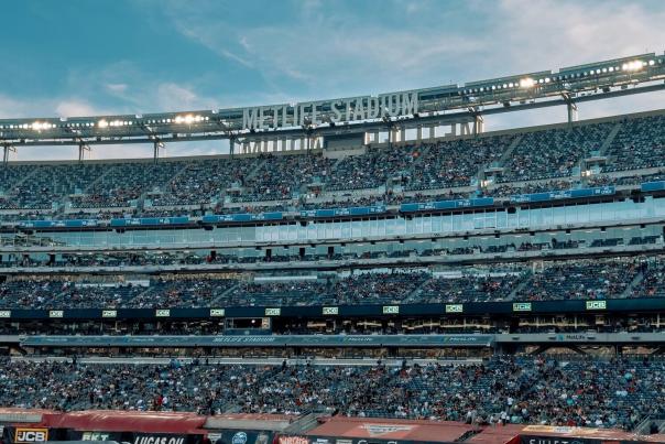 Packed crowd inside MetLife Stadium in East Rutherford New Jersey under evening lights selected as the host venue for the FIFA World Cup 2026 Final