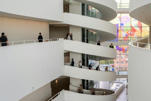 Modern art museum interior featuring sweeping architectural ramps and a bright open atrium