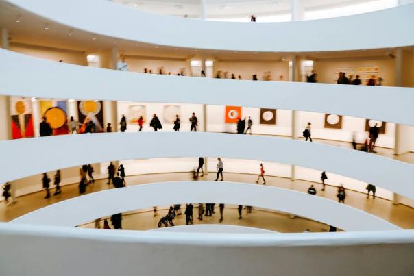 People walking briskly through a building interior in New York City — capturing the constant movement and collective flow that defines daily life in NYC