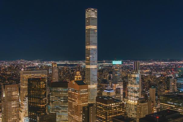 New York City skyline illuminated at night with Midtown skyscrapers — a view accessible from observation decks featured in major NYC city passes