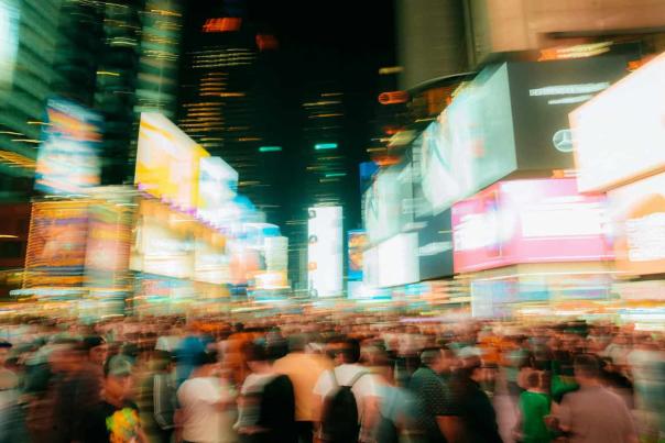 Crowds moving through Times Square in New York City at night