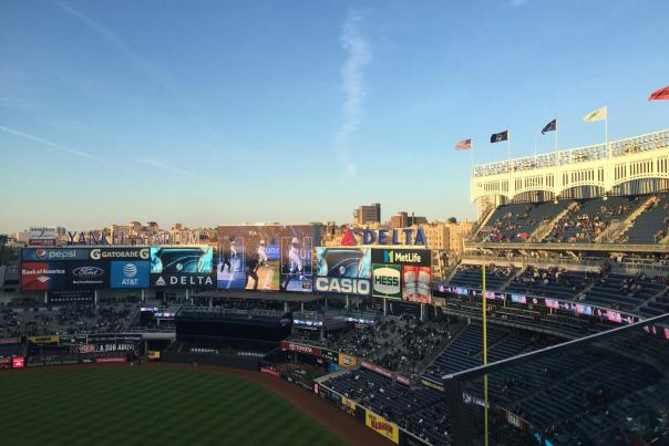 Yankee Stadium illuminated on Opening Day night with the baseball field lit up and stadium lights glowing in New York