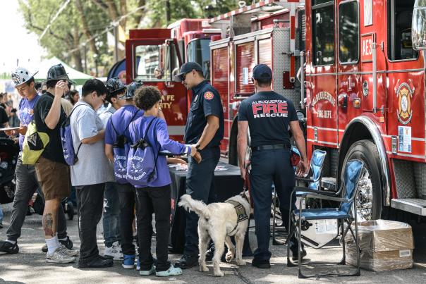 Children meet New Mexico firefighters and explore a fire truck during Main Street Days at the New Mexico State Fair.