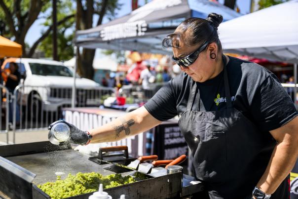 Leticia Romero, owner of Isleta Grill, seasons green chile for her burgers during the New Mexico State Fair.