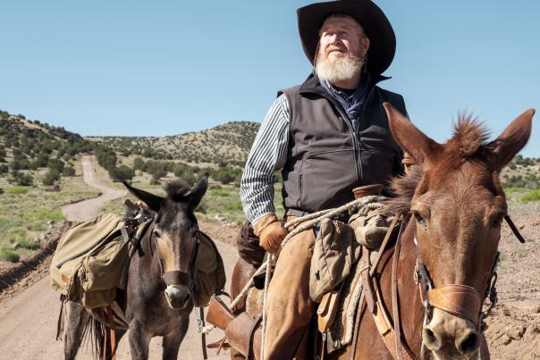 Brett Vaughn rides his mule Brenda as Ruth looks on at the Box, near Socorro.