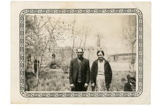Black and white portrait of Policarpio Valencia's son José del Carmen Valencia and his wife Elvira standing outside their home, circa 1941.