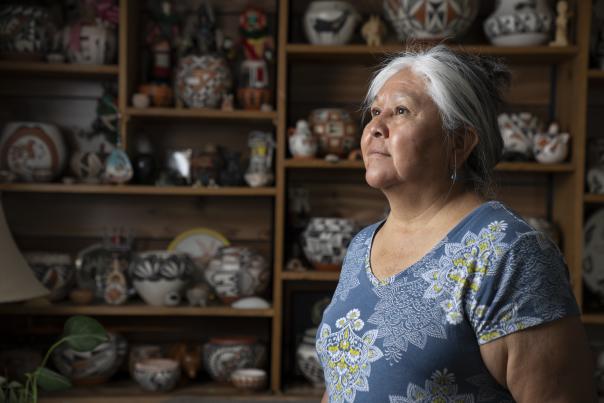 Acoma potter Claudia Mitchell and a collection of her work