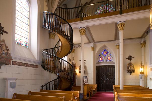 Photo of the spiral wooden staircase at Santa Fe's Loretto Chapel, known for its design with no visible supports.