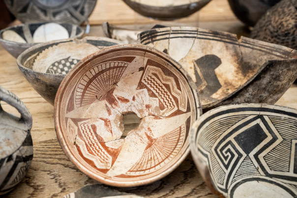 Pottery by Mimbres people with painted red and black designs.