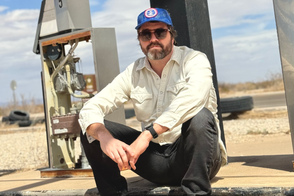 Joshua Wheeler sits on an abandoned gas pump along NM54 near his family's former ranch.