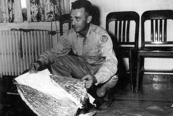 Major Jesse Marcel holds debris found near Roswell.