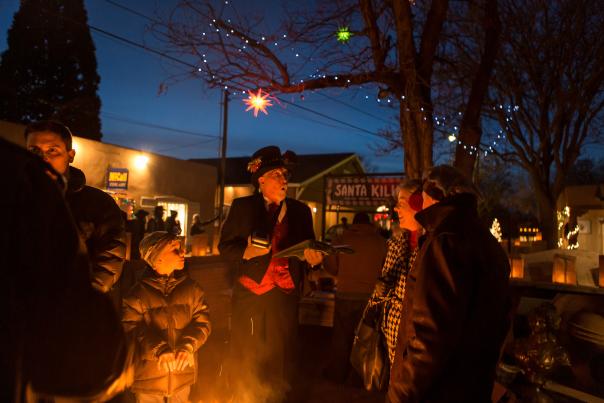 People gathered around a fire at the Canyon Road Farolito Walk.