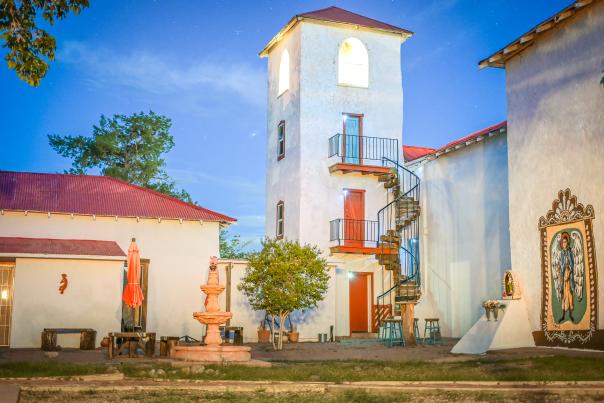 Historic St. Francis de Sales Inn tower in Hatch, New Mexico, a restored 1860 adobe church conververted into a boutique lodging stay.