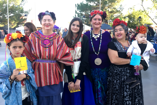 Kids and women dressed up for Dia de los Muertos.