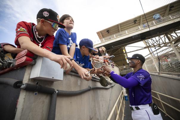 Julio Carreras signs autographs for young fans before the game.