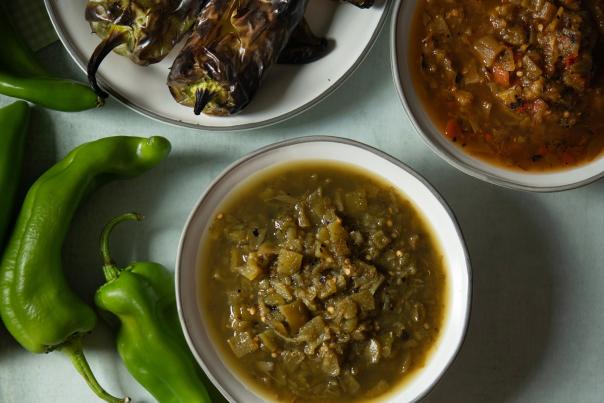 Roasted and fresh green chiles with a bowl of green chile stew.