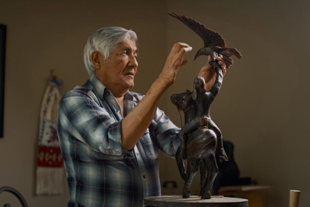 Michael Naranjo in 2022 with his sculpture "Earth, Fire and Wind."