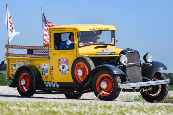 Vintage yellow race truck from The Great Race parked outdoors, representing the historic car rally travelling through New Mexico.
