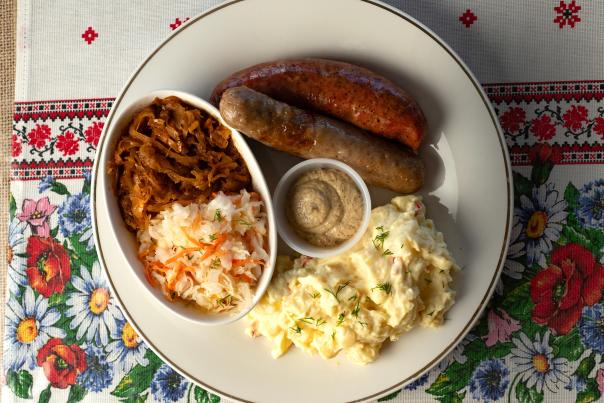 Red Rock Deli plates a pair of Polish sausages with sauerkraut and potato salad.
