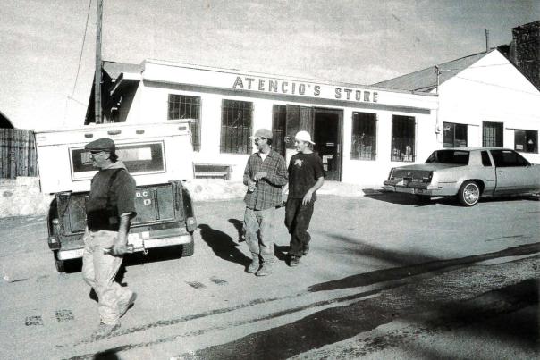 Locals hang out on the sunny side of Atencio's grocery store in Dixon, which once housed the U.S. Post Office.