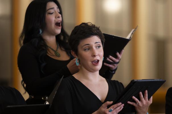 Two Santa Fe Desert Chorale vocalists performing during a holiday concert.