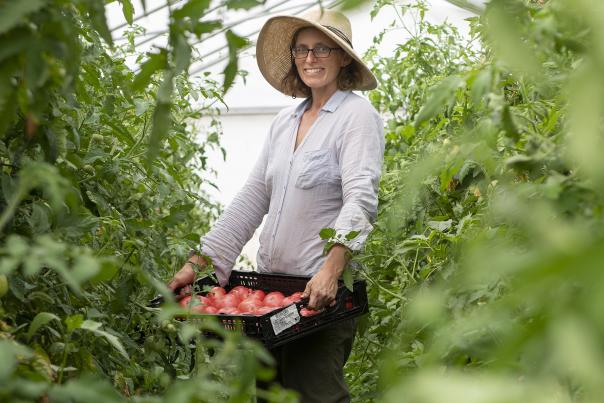 Lisa Anderson holds some fresh veggies on her farm.