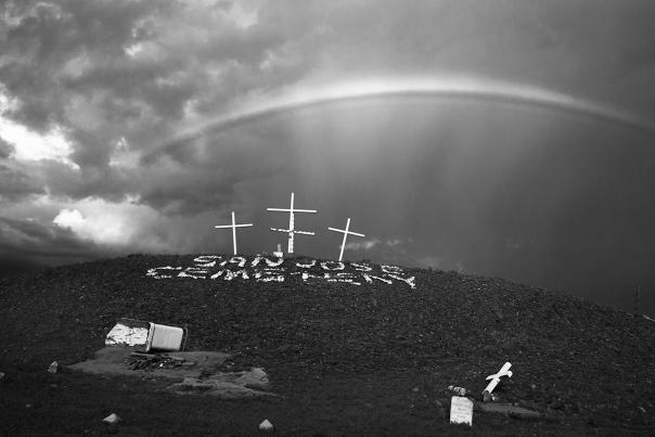 Black and white photograph of a cemetery in Albuquerque with a rainbow over it.