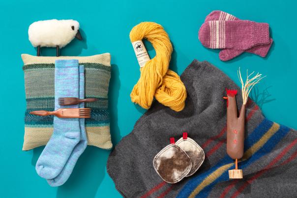 A variety of yarn, knitted items, and hand-crafted objects arranged on a turquoise background.