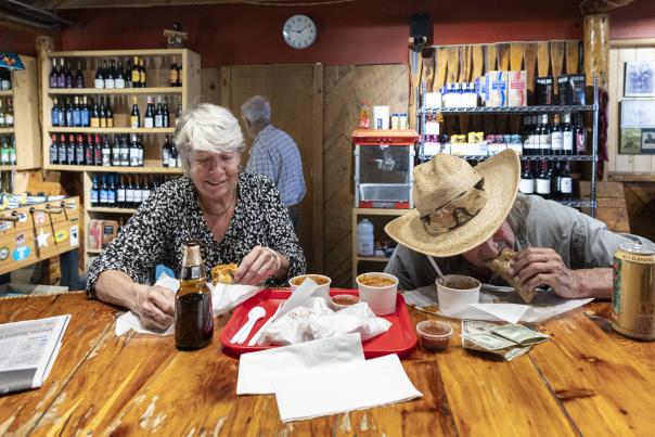 Two diners enjoying a meal at the rustic Abe's Cantina y Cocina in Arroyo Seco.