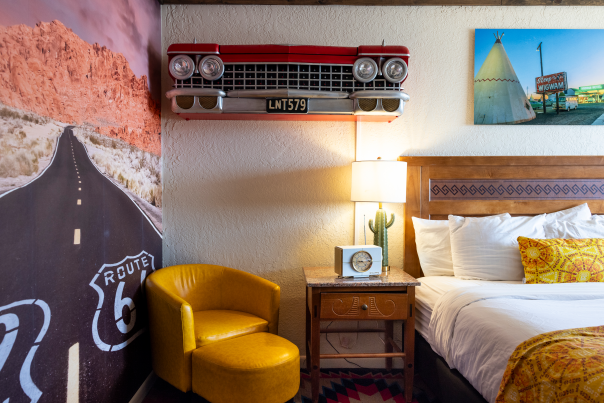 Retro-themed motel room at El Rancho Motel in Gallup, New Mexico, with Route 66 decor and classic car front mounted on the wall.