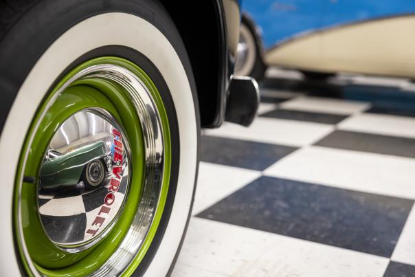 Vintage green-rimmed car tire on display at a Route 66 museum in New Mexico.